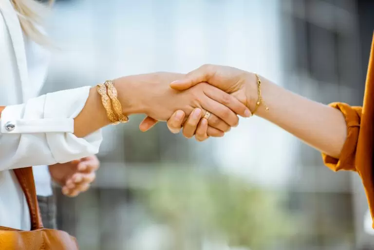 Businesswomen shaking hands outdoors